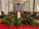 the church was decorated with candles and greenery